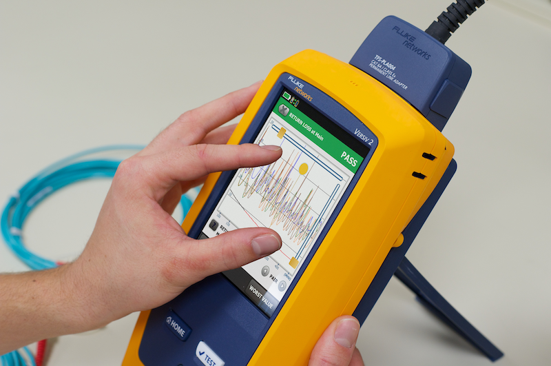 A handheld device showing onscreen measurement of an MPTL
